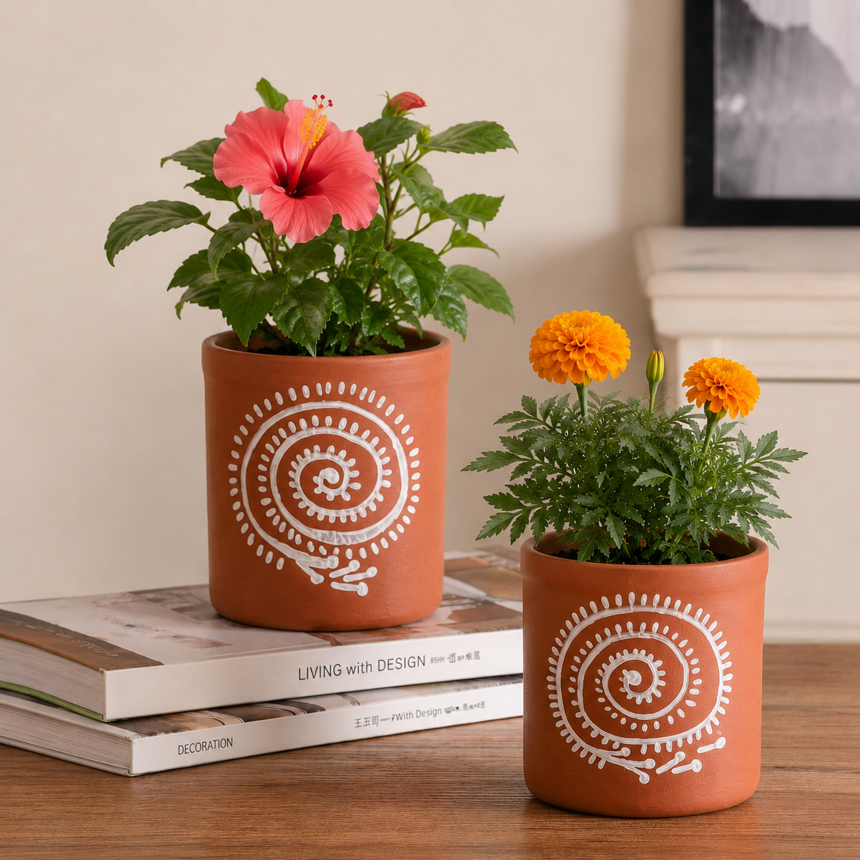 Two terracotta pots with decorative patterns containing potted plants on a wooden surface.
